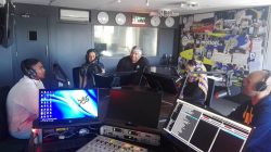Arrmien Brink(c) surrounded by youth on the weekly Sports Desk show