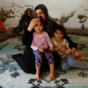 Palestinian woman Samah Abu Latifa, who fled her home amid Israeli strikes, shelters with her family in a kindergarten, in khan Younis in the southern Gaza Strip, October 10. REUTERS/Ibraheem Abu Mustafa